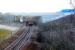 Running approximately 10 minutes late, an East Kilbride - Glasgow Central service passes under the bridge carrying the A726 on the approach to Thorntonhall on 11 February.<br><br>[John Steven 11/02/2010]