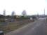 66522 in joint Shanks / Freightliner livery passing west light engine over the level crossing leading to the Bombardier Transportation maintenance depot at Crofton, near Wakefield; the lights of which are just visible over the hedge beyond the locomotive.<br><br>[David Pesterfield 17/02/2010]