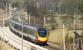 A southbound Pendolino rushes through Oubeck on its way from Lancaster to Preston on 4 March 2010 passing a Colas track machine  in the loop awaiting a path south.<br>
<br><br>[John McIntyre 04/03/2010]