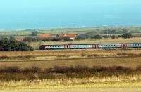 Spring time in Northumberland, an unidentified CrossCountry express races north near Alnwick on 7 March 2010.<br><br>[John Steven 07/03/2010]