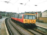 A service to Airdrie, formed by unit 303 065, calls at Partick in July 1997 <br><br>[David Panton /07/1997]