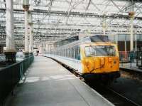 Edinburgh Waverley - 305 519 stands in the sunshine at the old North Berwick platform 7 (now 4) in April 1995.<br><br>[David Panton /04/1995]
