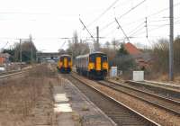 Multiple units pass on the slow lines at the south end of Leyland station on 13 March 2010. On the left is 156459 on a Blackpool North to Liverpool service, while on the right is 150207 arriving with the reverse working.<br><br>[John McIntyre 13/03/2010]