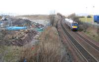 A Waverley bound train heads south past Gogar on 17 March with tram works in progress off to the left. The control tower of Edinburgh Airport stands in the left background. <br><br>[John Furnevel 17/03/2010]