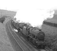 Stanier 8F no 48318 pilots Gresley V2 no 60813 on a southbound freight seen shortly after passing Beattock summit in the mid 1960s.<br><br>[Robin Barbour Collection (Courtesy Bruce McCartney) //]