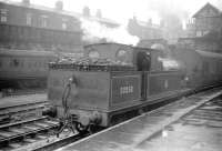 A Lancashire scene from the late 1950s with Aspinall ex-L&Y 2-4-2T no 50850, dating from the 1890s, waiting in the rain at Bolton  with a local train on 7 April 1959. (Bolton station, opened by the MB&B in 1838, carried the suffix 'Trinity Street' between 1910 and 1954). The locomotive, which was a resident of nearby 26C at the time, was eventually withdrawn from Southport shed at the end of 1961. <br><br>[Robin Barbour Collection (Courtesy Bruce McCartney) 07/04/1959]