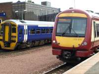 Passing trains at Larbert station on 9 April 2010.<br><br>[Brian Forbes 09/04/2010]