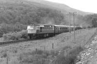 A Fort William - Glasgow train between Roy Bridge and Tulloch in July 1963 with a BRCW Type 2 in charge.<br>
<br><br>[Colin Miller /07/1963]