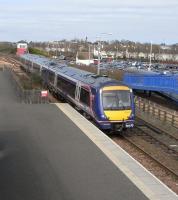 On 14 April 170 416 pulls into Leuchars with one of the hourly Dundee to Edinburgh semi-fast services. These trains are a fairly recent addition to the hourly Aberdeen services and have doubled the number of daytime services here, as well as doubling the work (or at least the lever-pulling) of the signalman in the box in the background. <br>
<br><br>[David Panton 14/04/2010]