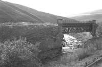 Approaching Inches station heading west towards Muirkirk in October 1964 with the Kennox Colliery branch coming in from the left and crossing the Douglas Water.  The bridge still survives but the railway is now a road at this point and no trace of Inches Station remains [See image 9066].<br>
<br><br>[Colin Miller /10/1964]