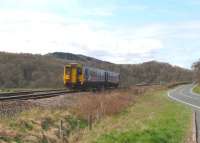 A Carlisle - Newcastle service formed by 156480 runs parallel to the A69 road approaching Haydon Bridge station on 18 April 2010.<br><br>[John Steven 18/04/2010]