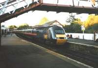 An Aberdeen to London GNER 125 pulls into Inverkeithing one teatime in early October 1998. The contemporary equivalent of this train still runs (at April 2010) - two operators on. The footbridge which frames the picture has since been removed and replaced with a more substantial structure at the other end of the platform. Today the station look more businesslike.<br><br>[David Panton /10/1998]