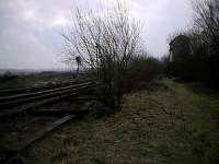 The disused signalbox at Penistone, seen in 2002, viewed from the trackbed of the former Woodhead Route. Route to Huddersfield to the left and straight on to Barnsley (and formerly Sheffield).<br><br>[Ewan Crawford 12/03/2002]