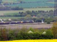 A Freightliner class 66 waits at signals by a barren section of Healey Mills yard with loaded coal wagons on 14 May 2010. Healey Mills TMD is located off picture to the right.<br><br>[David Pesterfield 14/05/2010]