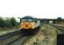 Class 56 No. 56078 runs light engine westwards through Knottingley, heading from the depot that lies immediately to the east of the station. In the background a Pacer that had arrived on a terminating service from Leeds via Castleford waits to drop back into the platform for the return trip. 56078 was taken out of service in May 2007 but after a long period of storage was returned to the main line with Colas in 2014 hauling Chirk bound log trains.<br><br>[Mark Bartlett 22/09/1994]