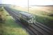 A southbound railbus approaching Lochgreen Junction near Troon, in August 1959, on a Kilmarnock - Dalmellington working. The Troon avoiding line can been seen coming in from the left in the background.<br><br>[A Snapper (Courtesy Bruce McCartney) 21/08/1959]