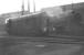 An almost new EE Type 1 stands alongside a not-so-new Stanier 8F outside the appositely named Grimesthorpe shed, Sheffield, in the spring of 1961. The shed, then coded 41B, had only a short time left at this point with official closure coming in September of that year (although it continued in use as a  stabling point for a time pending completion of the new 'super-shed' at Tinsley). Grimesthorpe shed was  eventually demolished in 1963. In the background stand the chimneys of the Cammell Laird Grimesthorpe works, closed in the 1980s.<br><br>[K A Gray 19/03/1961]