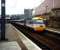 A 125 in BR InterCity livery at Haymarket Platform 4 in April 1995.  If you're wondering what it is that has changed that blank-faced building on Distillery Lane has been replaced with flats.  I hope residents appreciate the view (and sounds).<br><br>[David Panton /04/1995]