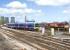 Scene at Didcot on 8 April 2010 as a Paddington bound First Great Western 165 DMU coming off the Oxford line passes 66024 on a freight.<br><br>[Peter Todd 08/04/2010]