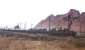 A train of new cars and lorries trundles past Uphall signal box on 23 February 1965, dwarfed by the local shale bing.<br><br>[Frank Spaven Collection (Courtesy David Spaven) 23/02/1965]