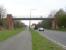 View west along the A89 on 23 April 2010 towards the traffic lights at Station Road crossroads. The old bridge that once carried trainloads of shale to Uphall oil works [see image 28599] is now part of a walking/cycling route linking Uphall village and Uphall Station to the south.<br>
<br><br>[John Furnevel 23/04/2010]