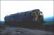 In fading light in a field near Forteviot in June 1982 stands badly damaged Class 47 no 47522. The locomotive had been working the 1335 Glasgow Queen Street - Aberdeen a month earlier on 4 May, when it ran into a tractor on a farm crossing nearby. The driver had seen the obstruction and was able to reduce speed but was still running at around 50mph at the point of impact. All except the last coach of the train left the rails and plunged 35 feet down an embankment. Some 62 people, including the train crew, sustained injuries, although, fortunately, there were no fatalities. 47522 was subsequently repaired at Crewe and continued in service until 1988. The 47 became something of a celebrity for a time, carrying a unique LNER-style apple green livery.<br>
<br><br>[Bruce McCartney 05/06/1982]