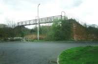 This footbridge is adjacent to the Level Crossing on the South Leith branch at Marine Esplanade.  As 1) there aren't many trains on this branch 2) Marine Esplanade is not nearly as alluring as it sounds and only directly leads to a sewage works 3) access to the bridge is almost impossible because of the vegetation I doubt anybody used this then (April 1995) or uses it now. [See image 28997] <br><br>[David Panton /04/1995]