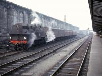 A quiet period at Carlisle station in the mid 1960s as Ivatt 2-6-2 tank no 41264 takes a break from shunting parcels vans to replenish its tanks from a hose in the west sidings. The locomotive spent the final period of its working life at Upperby after arriving there from Bradford (Low Moor) shed in 1965. <br><br>[Robin Barbour Collection (Courtesy Bruce McCartney) //]