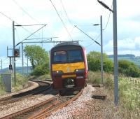 320318 approaches Brooks Farm LC between Cardross and Ardmore with a service to Helensburgh Central on 28 May 2010. The photo can be compared with one which was taken from the same spot some 37 years earlier [see image 18525]. The distant signal in the earlier shot was replaced during the Yoker area resignalling and the present signal is approximately 30 yards further east.<br>
<br><br>[John McIntyre 28/05/2010]