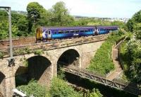 An Edinburgh Waverley - Glasgow Central via Shotts train about to cross the Water of Leith on Slateford Viaduct on a very warm and sunny 3 June 2010. The 1237 stopping - service has just left Slateford station, with its next scheduled call, Kingsknowe, almost in sight.  <br>
<br><br>[John Furnevel 03/06/2010]