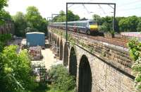 The 1247 'East Coast' Glasgow Central - Kings Cross train crossing Slateford Viaduct on 3 June 2010, some two miles short of its next scheduled stop at Haymarket. The substantial parallel structure on the far left of the photograph is the aqueduct carrying the Union Canal.<br><br>[John Furnevel 03/06/2010]