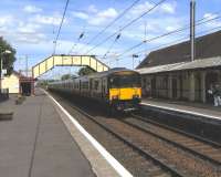 A 6-car 318 arrives at Prestwick Town on 3 June with a service for Ayr.<br><br>[David Panton 03/06/2010]