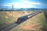 One of Haymarket's finest, no 60011 <I>'Empire of India'</I>, sweeps through Musselburgh on 16 July 1955 carrying the headboard of the down <I>Flying Scotsman</I>. On the right the freight lines from Monktonhall Junction climb towards the camera.<br><br>[A Snapper (Courtesy Bruce McCartney) 16/07/1955]