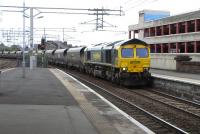 Freightliner 66 598 accelerates through Paisley Gilmour Street on the Down Ayr line on 14 June after biding its time in Arkleston loop.<br><br>[David Panton 14/06/2010]