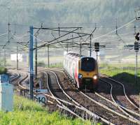A southbound Voyager passes the empty loops at Beattock Summit. The (seemingly unending supply of) trucks are on the M74 in the background.<br><br>[Ewan Crawford 14/06/2010]