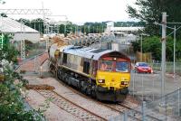 66162 slowly passes over the level crossing located to the east of the former Bathgate Upper station. The new station can be seen in the background. This ballast train halted after crossing to await instructions.<br><br>[Ewan Crawford 27/06/2010]