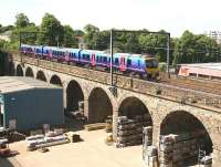 The 1208 TransPennine Express service from Edinburgh to Manchester Airport crosses Slateford Viaduct westbound on 3 June 2010. The train's next stop will be at Lockerbie.<br><br>[John Furnevel 03/06/2010]