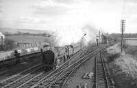 <I>Taking a run at it...</I> Shunning all thoughts of assistance, Britannia Pacific no 70016 <I>Ariel</I> storms north through Beattock station in the mid sixties heading for <I>the bank</I>. 70016 arrived at Kingmoor in 1965 and spent its final two years there, being withdrawn by BR at the end of August 1967.  <br><br>[Robin Barbour collection (Courtesy Bruce McCartney) //]