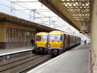 Class 334s coming from (left) and heading for Gourock meet at Paisley Gilmour Street on 14 June 2010.<br><br>[David Panton 14/06/2010]