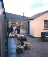 Still a multi-purpose train to Kyle in the summer of 1974 - parcels and mail being offloaded from the mid-morning train ex-Inverness at Achnasheen.<br><br>[David Spaven //1974]