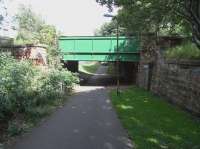 Course of the CR's Leith New Line (1903 to 1968) as it passed under <br>
Ferry Road, looking north on 12 July 2010.For a view the other way in 1963 [see image 28071]. The former cutting from Newhaven Junction to the old Chancelot Mill has been substantially filled in, but there's a dip here to allow the walkway to go under Ferry Road. Platforms were built here (as elsewhere on the line) for a station which never opened, the line remaining goods only. If you can see a council van coming towards me, it's more than I did. <br>
<br><br>[David Panton 12/07/2010]