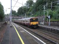 The tendency for Scottish placenames to sound more romantic than than the actuality, and the tendency for rail locations to look more leafy than their immediate surroundings come together at Cambuslang, where 318 262 is seen calling with a Dalmuir service on 14 July. <br>
<br><br>[David Panton 14/07/2010]