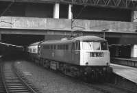 The 10.27 Manchester Piccadilly - London Euston stands in the concrete cavern that is Birmingham New Street station on 1 November 1969. Class 85 AC electric locomotive no E3090 is in charge. <br><br>[Bill Jamieson 01/11/1969]