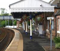 The up platform at Aberdour on 15th July 2010. The hanging baskets are a treat. <br>
<br><br>[Brian Forbes 15/07/2010]