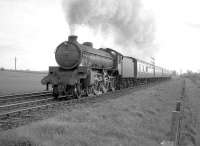 B1 no 61029 <I>Chamois</I> with an up train on the ECML west of Prestonpans in April 1964. (The train is possibly the Dunbar local that left Waverley around 5.38pm and Prestonpans at 6.01pm.) Dolphingstone LC is behind the train and Morrisons Haven SB can be seen in the right background. Major realignment of the ECML was carried out in this area some 40 years later due to subsidence resulting from old mine workings [see image 24240].<br><br>[Robin Barbour Collection (Courtesy Bruce McCartney) 22/04/1964]