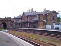 The main station building at Cupar. View across the lines from the southbound platform on 18 July. The A914 crosses the railway on the bridge in the left background.<br><br>[Andrew Wilson 18/07/2010]