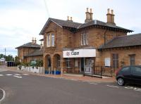 The main station building at Cupar, complete with its impressive floral arrangements, seen here looking north from the car park on 18 July 2010.  <br><br>[Andrew Wilson 18/07/2010]