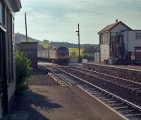 To my delight (!) Sprinters were withdrawn from the Inverness - Aberdeen line shortly after introduction and locomotive hauled trains hastily re-introduced. My delight being due to not having photographed the line in any great detail. In hot summer weather an Aberdeen bound service slows as it enters Insch station in 1990.<br><br>[Ewan Crawford //1990]