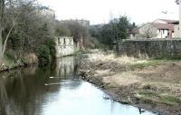 The second NB crossing of the Water of Leith between Bonnington South and East Junctions in March 2003. Beyond the bridge remains is one of the surviving columns which supported the higher level Caley line on its way to Leith East [see image 2196].<br><br>[John Furnevel 10/03/2003]