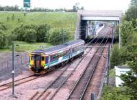 A train leaving the new reversing siding at the north end of Millerhill yard for Newcraighall station (under the bridge) to commence a Newcraighall - Dunblane service on 4 June 2002, the opening day of passenger services between Newcraighall and Edinburgh Waverley.<br><br>[John Furnevel 04/06/2002]